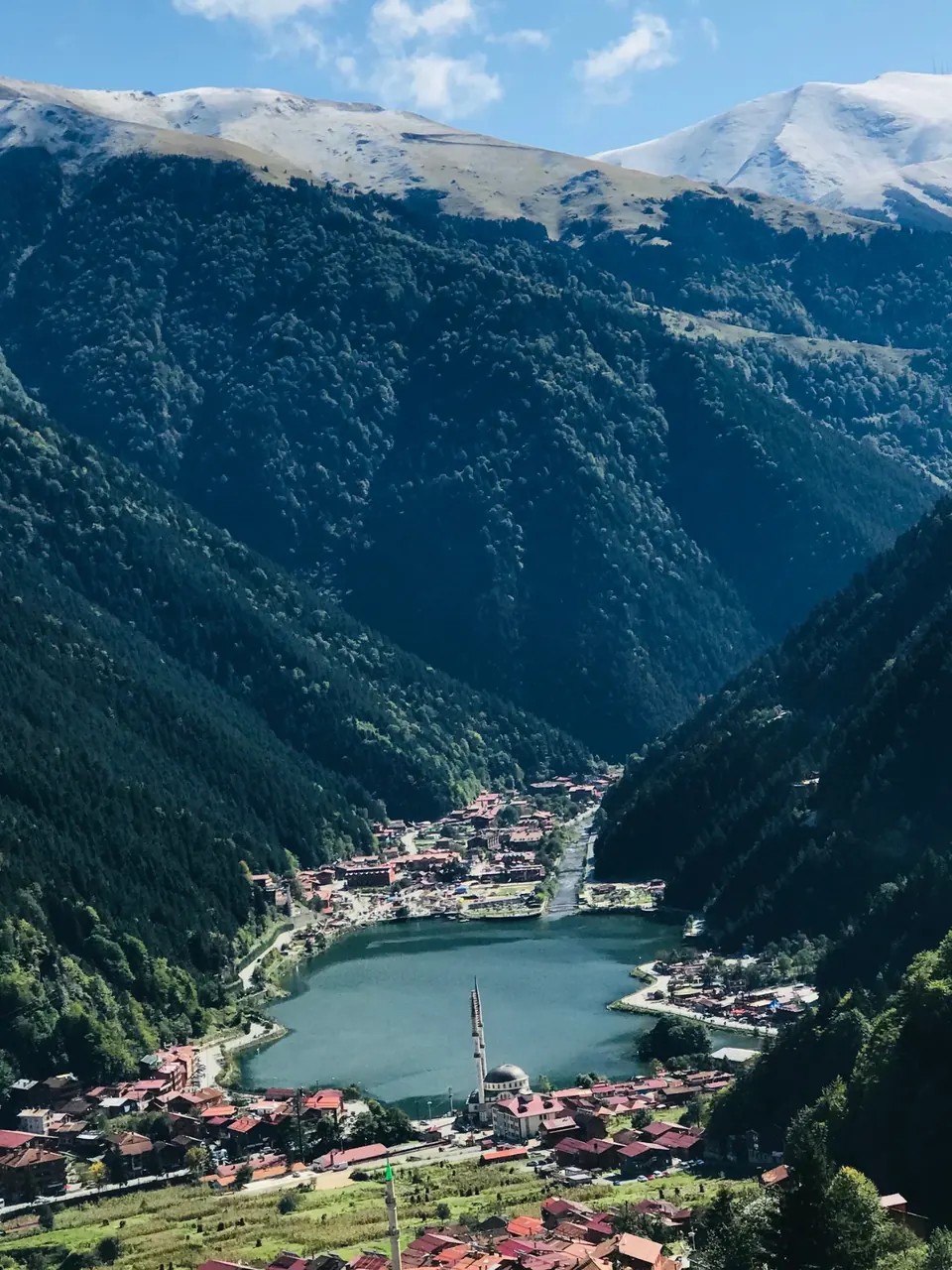 Uzungöl in the Black Sea mountains: a lake and its village in a forested valley below snowy peaks