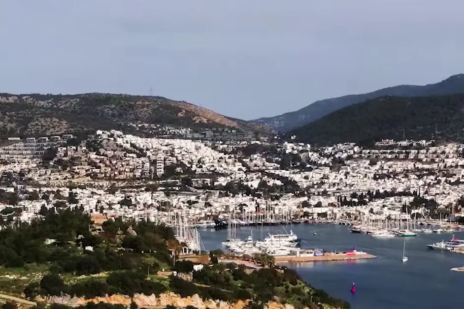 Bodrum's white houses on the hills above the marina and its masts, the bay in the foreground